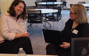 Two women at a PD session laughing