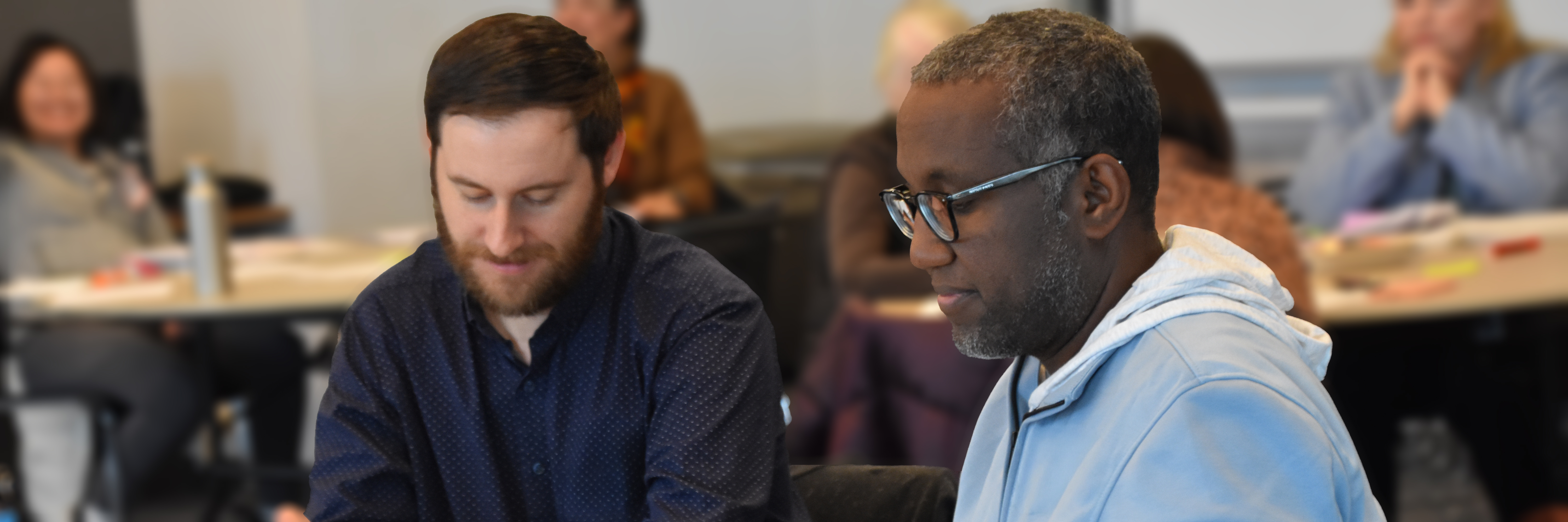 2 adult ed instructors during a PD session.