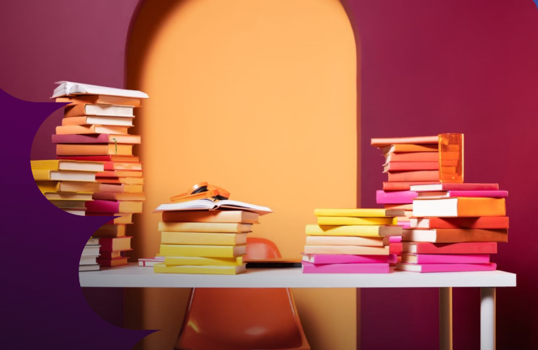 desk with many piles of books