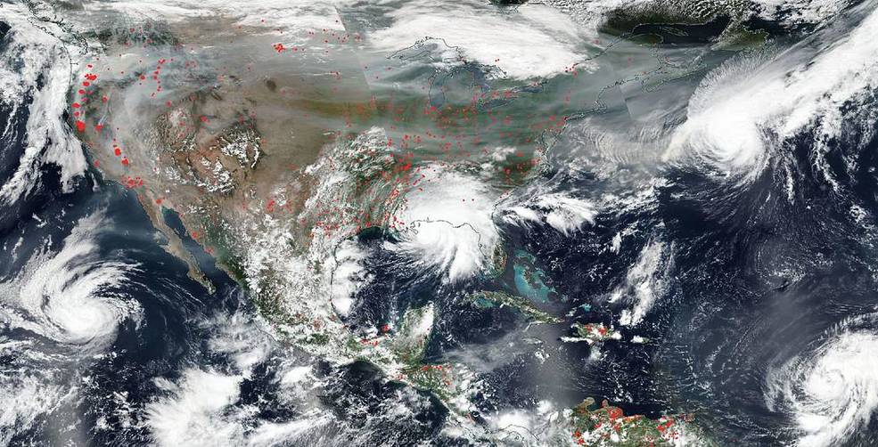 NASA satellite photograph of the Earth, showing cloud cover and wildfires