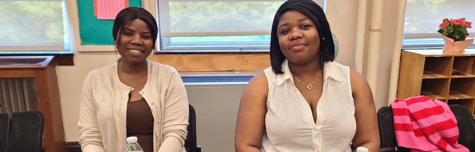 Two adult education students sitting at a table