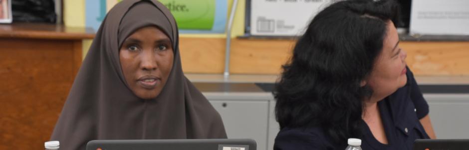 Two adult education students sitting at a table