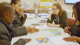 ELL students and teacher use math manipulatives