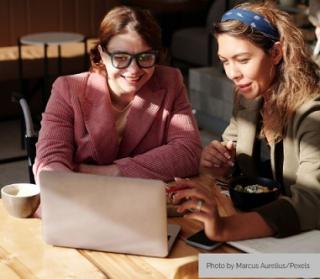 two women collaborating at a computer