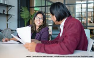 teacher and adult student talking