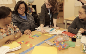 Female ESOL math students at table.