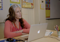 screenshot of teacher at desk